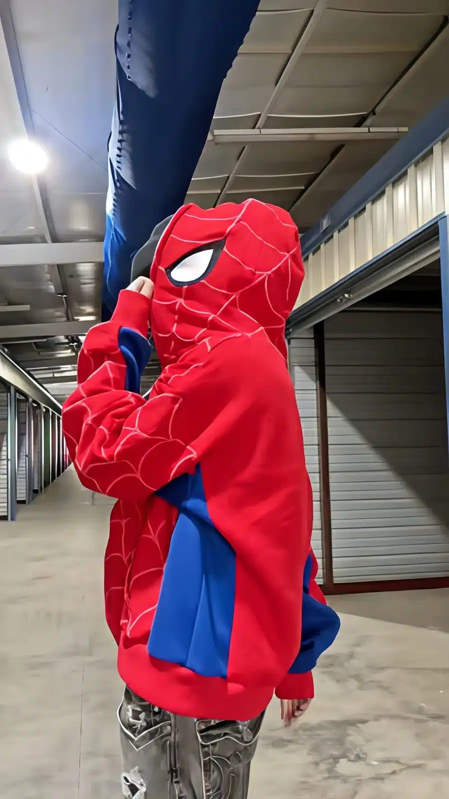Person wearing a Spider-Man costume in an indoor setting